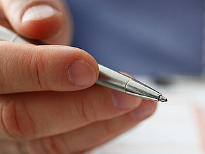 Male insurer hand hold silver pen an accident