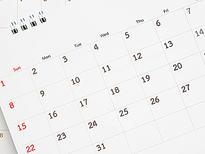 calendar page close up on blue background business planning appo